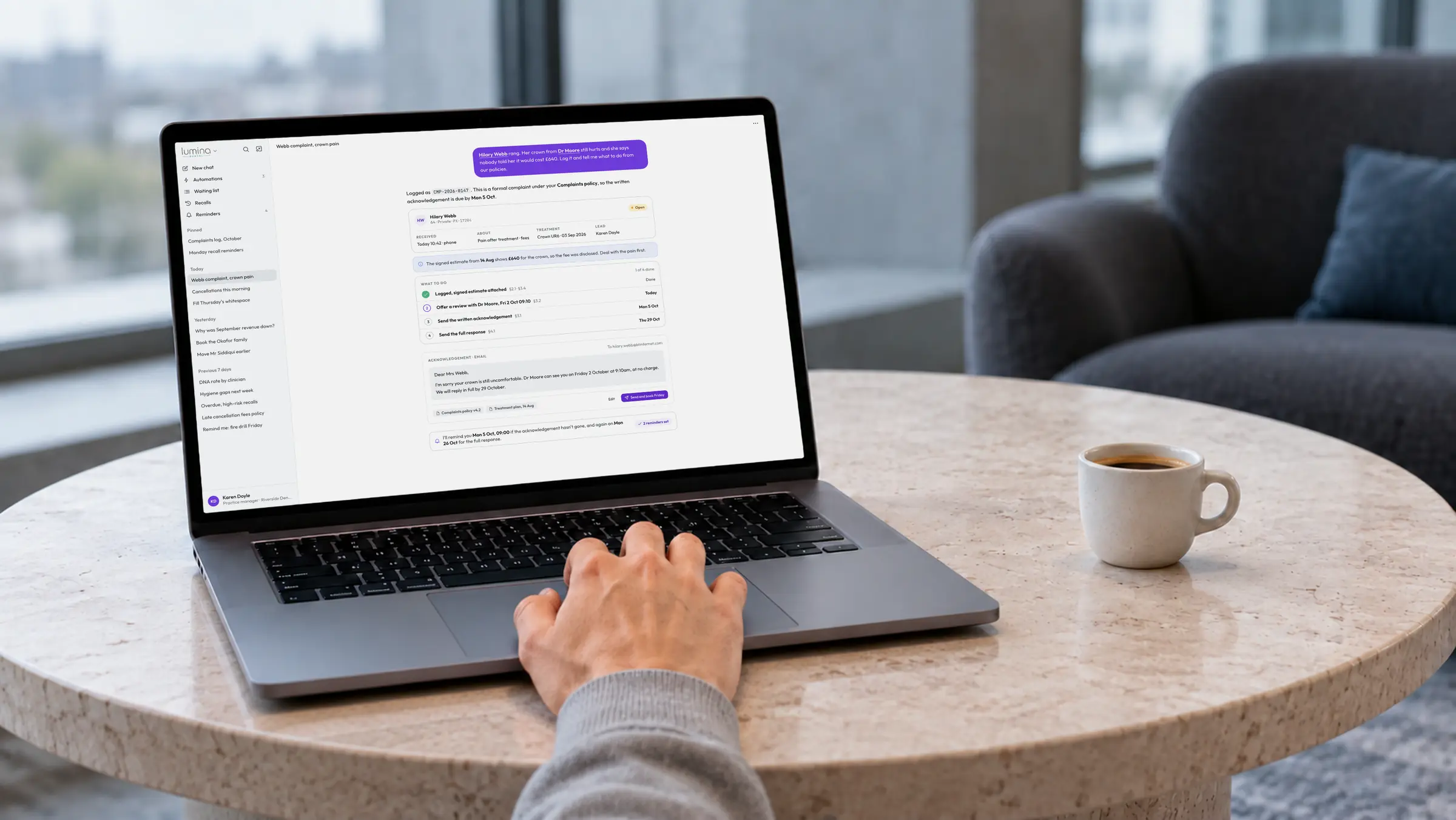 A practice manager using Lumina Intelligence on a laptop